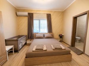 a bedroom with a large bed and a tub in it at Guest House Costa 1 in Karianí +24 photos