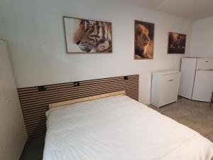 a bedroom with a bed and three pictures on the wall at Mercury Room in Limbiate