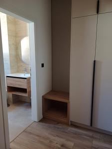 a bathroom with a sink and a mirror at Apartmani KIKO in Međugorje