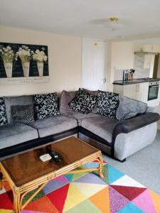 a living room with a couch and a coffee table at Fox and Hounds Apartment in Willingham