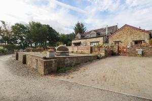 an old stone house with a brick driveway at Skylark in Liskeard