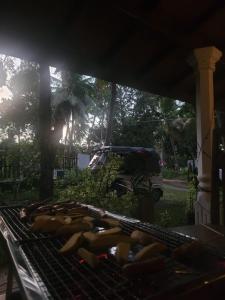 a grill with a bunch of hot dogs on it at Rio Lake Hotel Sigiriya in Habarana