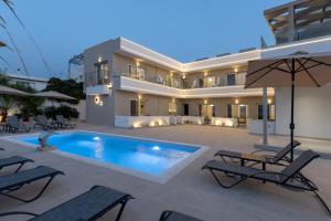 a villa with a swimming pool in front of a building at Amara Cove Adults Only by Estia in Malia