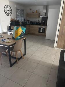a kitchen with a table with a bag on it at L appart in Joué-lès-Tours