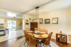 a dining room with a table and chairs at Lrge 5 BR 9 Beds Near DC-Pool, Hot Tub, Gym, Game Rm, Fire Pit in Bowie