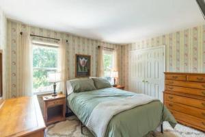 a bedroom with a bed and a dresser and a window at Lrge 5 BR 9 Beds Near DC-Pool, Hot Tub, Gym, Game Rm, Fire Pit in Bowie +34 photos