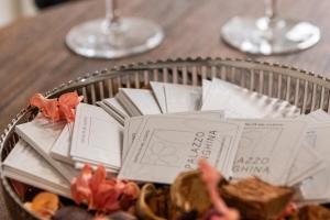 a table with a basket of food and wine glasses at Palazzo Menghina in Casaletto Spartano
