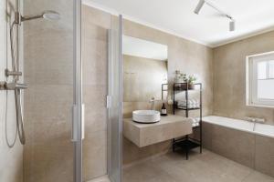 a bathroom with a sink and a shower at Landhaus Steiner in Altenmarkt im Pongau +71 photos