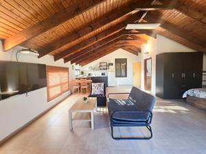 a living room with a couch and a table at Assaf's place - המקום של אסף in Aẖihud