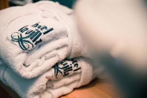 a pile of towels sitting on top of a table at Hotel La Villa in La Villa