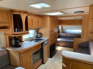 a kitchen in an rv with a sink and a stove at Helska Ostoya in Hel
