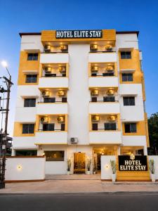 a hotel building with a hotel elitestay sign on it at Hotel Elite Stay in Bori
