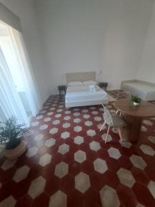 a room with a bed and a table and a floor at Relais Soleil in Vico Equense