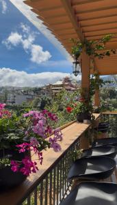 a balcony with chairs and flowers on a balcony at Sun Hill Villa in Lao Cai