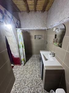 a bathroom with a sink and a shower at Guest House For Rent Merzane in Merzane