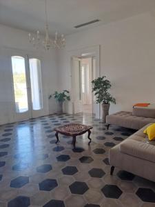 a living room with a couch and a coffee table at Relais Soleil in Vico Equense