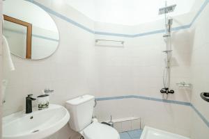 a bathroom with a toilet and a sink and a mirror at Hotel Boutique Vioalv in Sarandë