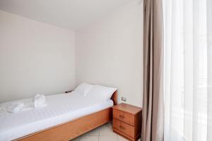 a small bedroom with a bed and a window at Hotel Boutique Vioalv in Sarandë +123 photos