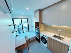 a small kitchen with a sink and a washing machine at Gang Thep Hotel in Thái Nguyên