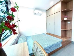 a small bedroom with a bed and a window at Gang Thep Hotel in Thái Nguyên