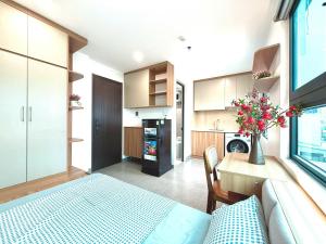 a kitchen with a bed and a table in a room at Gang Thep Hotel in Thái Nguyên