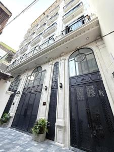 a building with two large black doors on it at Gang Thep Hotel in Thái Nguyên