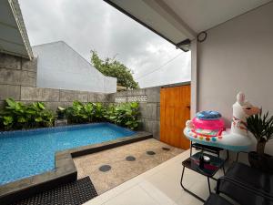 a swimming pool in the backyard of a house at Villa Ostara Kota Batu in Batu