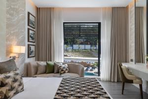 a hotel room with a bed and a desk and a living room at The Encore Hotel Nakuru in Nakuru +58 photos