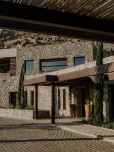 a stone building with awning in front of it at Tropicana Suites & Villas Mykonos in Paradise Beach +135 photos