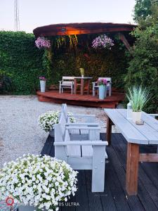 a patio with a table and benches and flowers at Hotel Karczma u Macieja in Bolków +27 photos