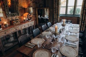 a long wooden table with chairs and candles on it at The Roebuck Inn in Mobberley +42 photos