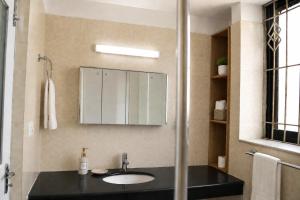 a bathroom with a sink and a mirror at Du Nepal Inn in Kathmandu +8 photos