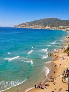 a group of people on a beach near the ocean at APPT T2 lux berr in Aïn El Turk