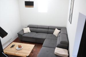 a living room with a couch and a coffee table at Gîte de la Dheune in Essertenne +7 photos