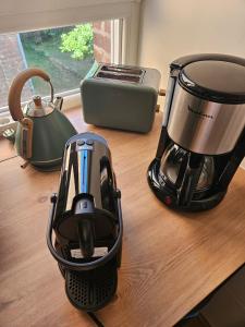 a blender and a tea kettle on a wooden counter at Le Forest Lodge 325 in Béthune