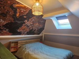 a bedroom with a large map on the wall at Le Forest Lodge 325 in Béthune