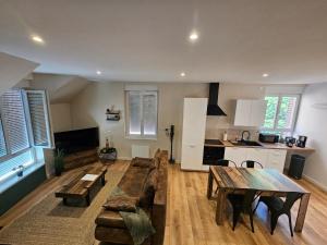 a living room with a couch and a table at Le Forest Lodge 325 in Béthune