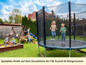 a group of children playing on a trampoline at Ferienwohnung Morgensonne am Kurpark Bad Berka # gratis Parkplatz # ebenerdig # Spielplatz # WLAN # 2 Schlafzimmer # Nähe Weimar, Erfurt # Weimarer Land # Smart-TV in Bad Berka +35 photos