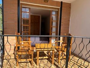 a balcony with a table and chairs on a patio at Casa Lobo in Ucero