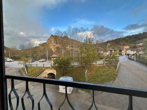 a balcony with a view of a road and a bridge at Casa Lobo in Ucero