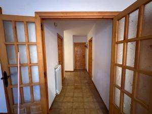 an empty hallway with a door and a room with a radiator at Casa Lobo in Ucero