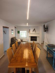 a living room with a wooden table and chairs at Casa Limón - Alpujarras in Órgiva +10 photos