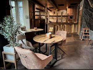 a dining room with two tables and chairs at Vanaga Ligzda in Baltezers