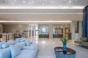 a living room with a white couch and a table at Daegu Hyeonpung Prana Hotel in Daegu +129 photos