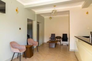 a living room with chairs and a table at Hotel Amani Limited in Mwana Island
