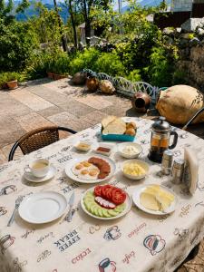 a table with plates of food on it at Pottery House Sanahin in Alaverdi