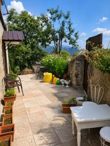 a patio with tables and chairs and plants at Pottery House Sanahin in Alaverdi
