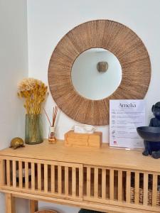 a mirror sitting on top of a wooden shelf at Amelia Apartment in Maniago