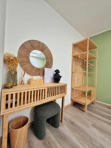 a dressing table with a mirror and a shelf at Amelia Apartment in Maniago