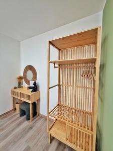 a room with a wooden shelf and a table at Amelia Apartment in Maniago